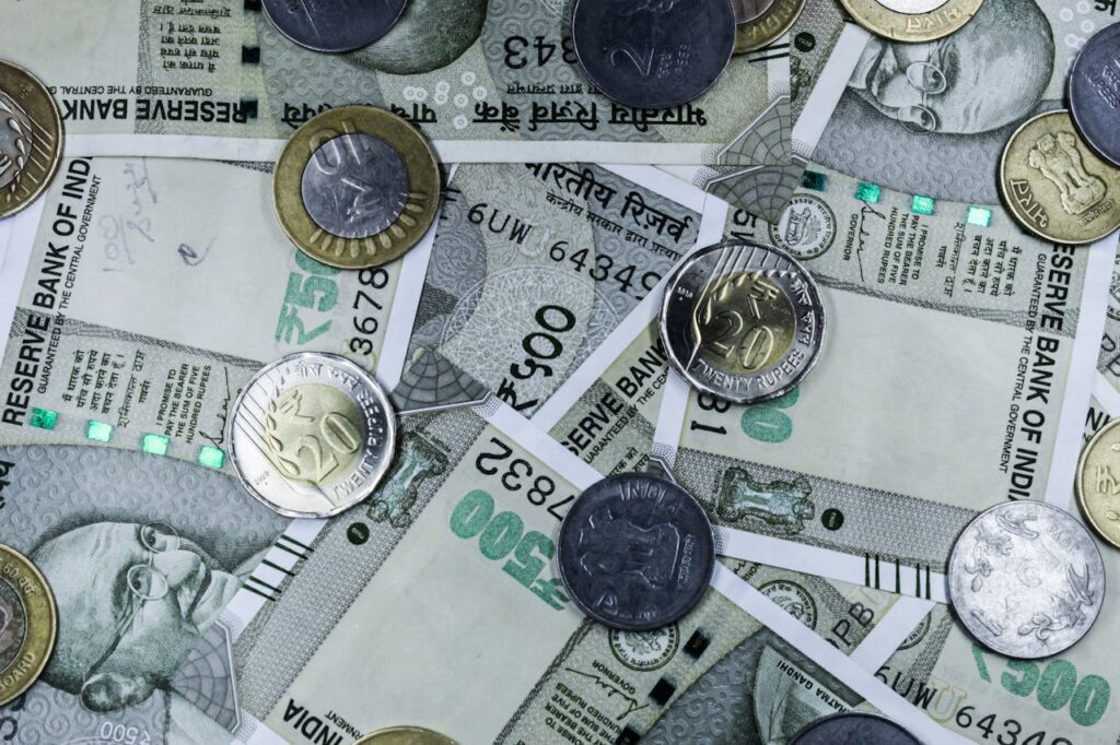 pexels-photo-14907339 Top view of various Indian rupee banknotes and coins, highlighting financial themes.